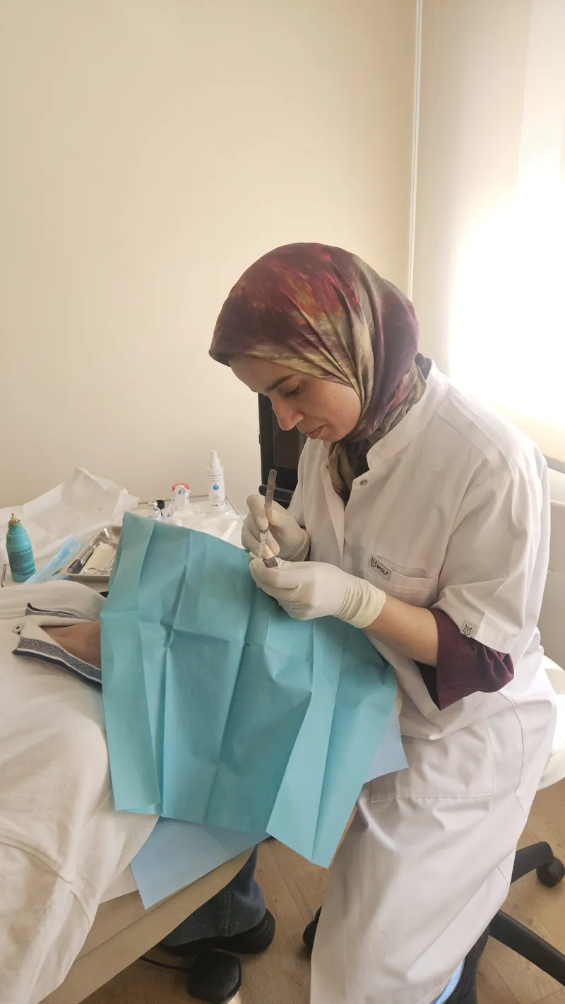 Le Dr ESSADEQ réalisant un acte de petite chirurgie dermatologique au cabinet de Rabat